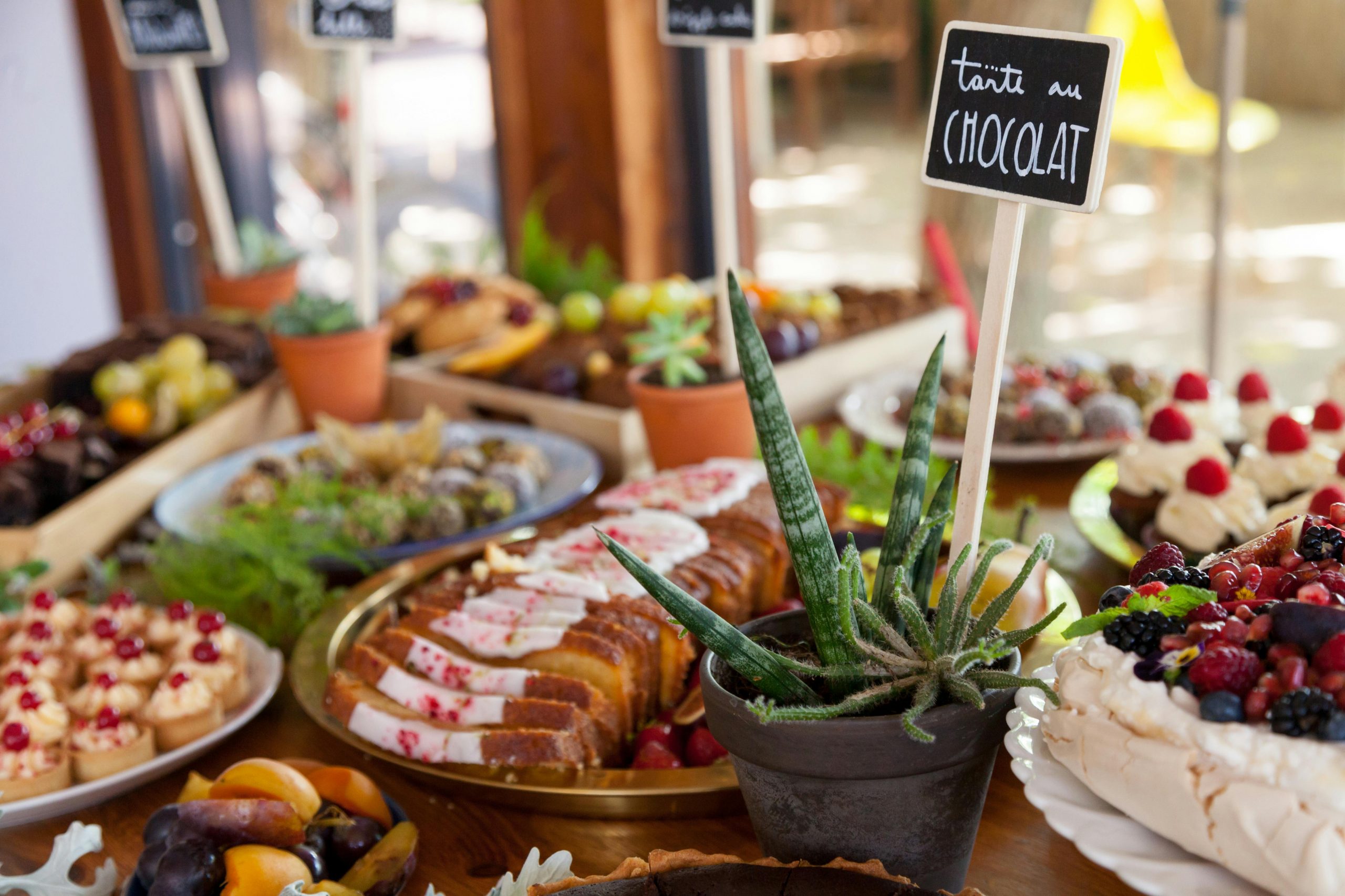 assorted desserts displayed on a buffet table